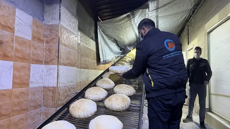 Bakery workers preparing bread for Bread For Life charitable distribution