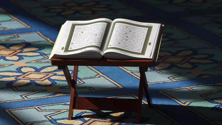 Open Quran pages showing Islamic scripture and religious text