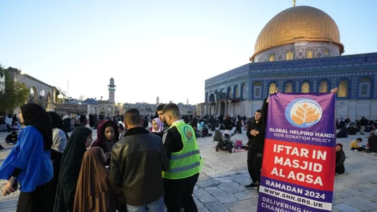 Iftar at Masjid Al Aqsa beside the Dome of the Rock with the Global Helping Hands banner