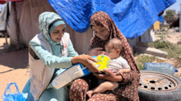 Palestinian infants receiving emergency baby milk and feeding supplies
