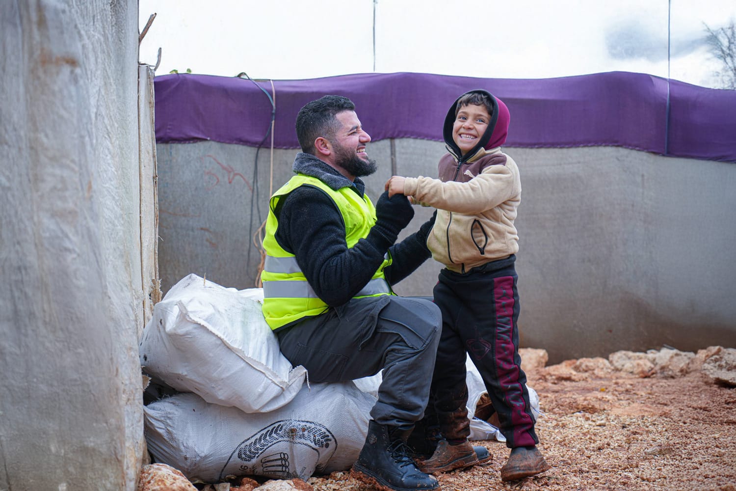 Ramadan food distribution showing families receiving iftar meals and supplies
