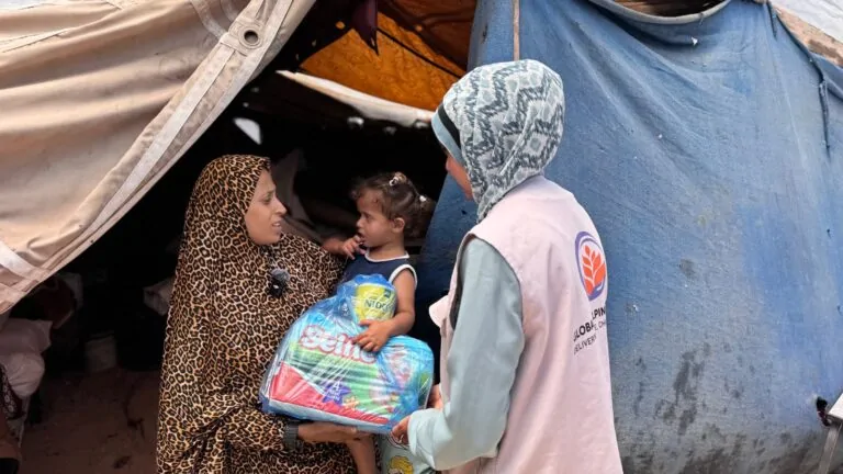 Mother receiving baby milk and nappies in Palestine