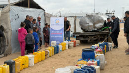 Field photo of charity distribution event with community members