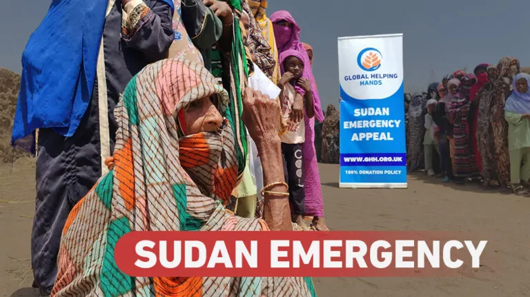 Sudan Emergency appeal: an elderly woman waiting in a queue for aid