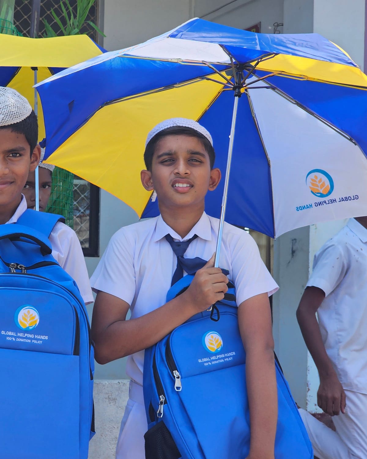 Pupils with Global Helping Hands school bags and umbrellas in Sri Lanka