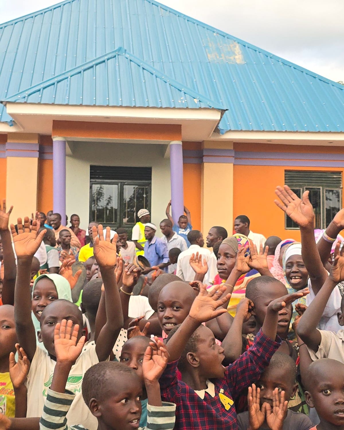 Children cheering at the opening of a masjid in Uganda