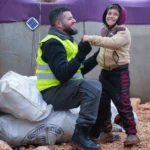 Smiling children in warm winter clothes from Global Helping Hands