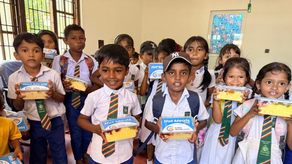 Children holding their meals from Global Helping Hands in Sri Lanka
